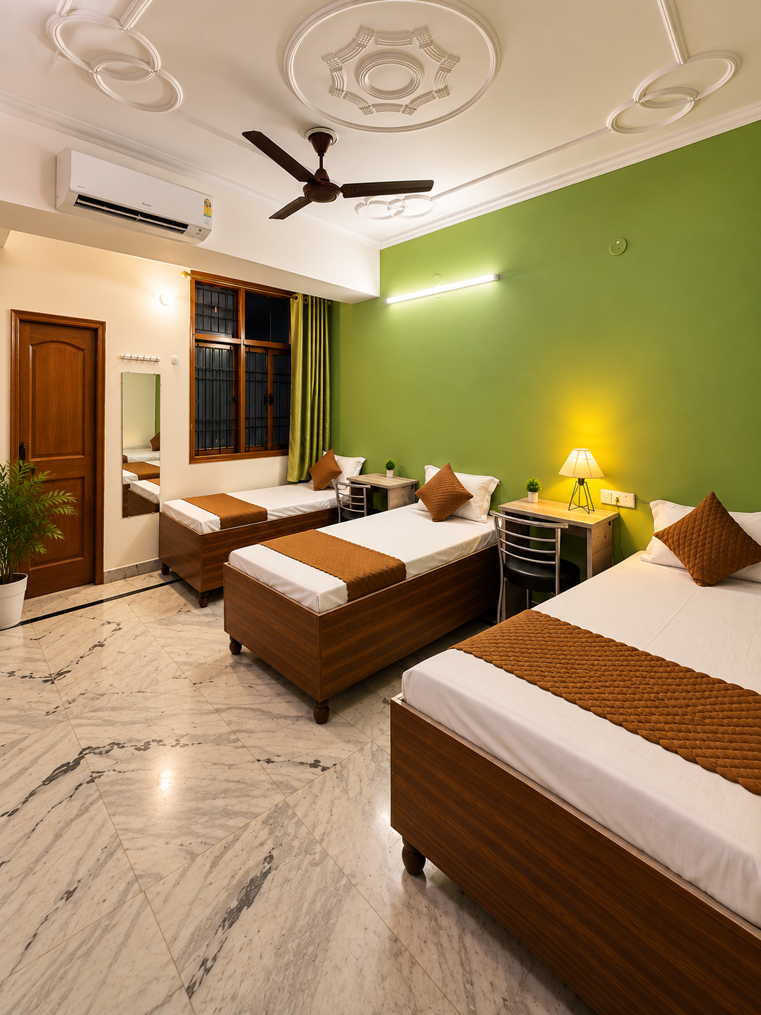 Comfortable furnished room with beds, mirror and study area at Serenity PG Noida