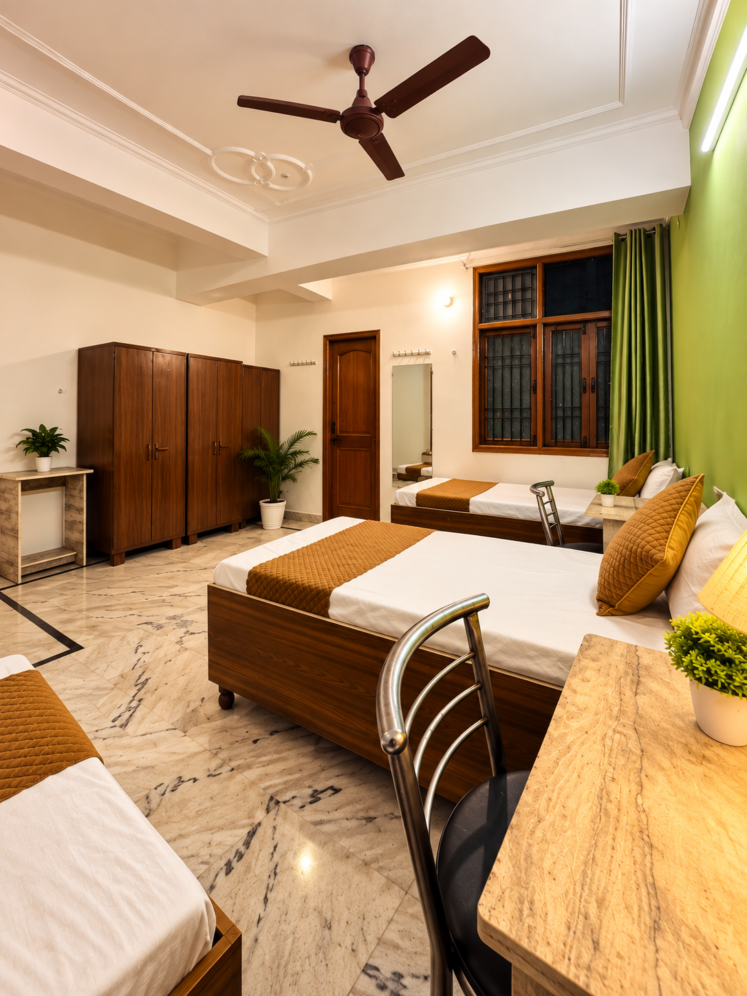 Furnished room with study desk, beds and wardrobes at Serenity PG in Sector 126 Noida